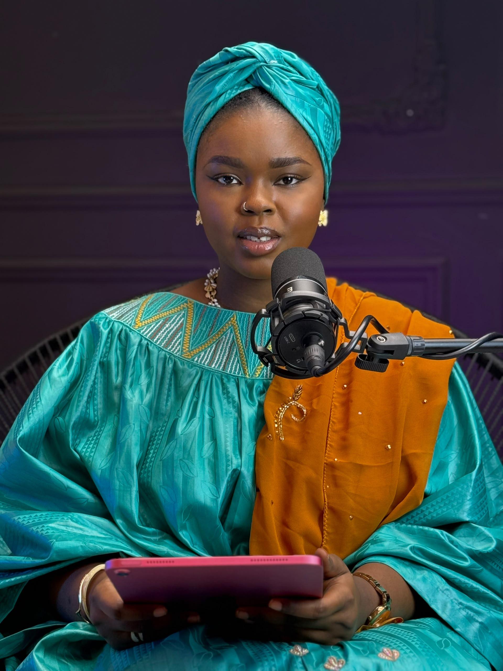 Halima recording an episode at the microphone